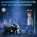 Berniukas prie juodai balto vaikų BMW motociklo, 99 cm ūgis