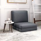Tamsiai pilka grindų sofa-lova kambaryje prie staliuko