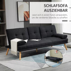 Juoda sofa išskleista į lovos padėtį su patalynė ant kilimo