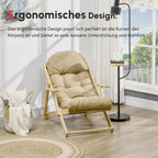 Šviesiai rudas ergonomiškos formos krėslas prie lango svečių kambaryje su grindine lempa ir staliuku