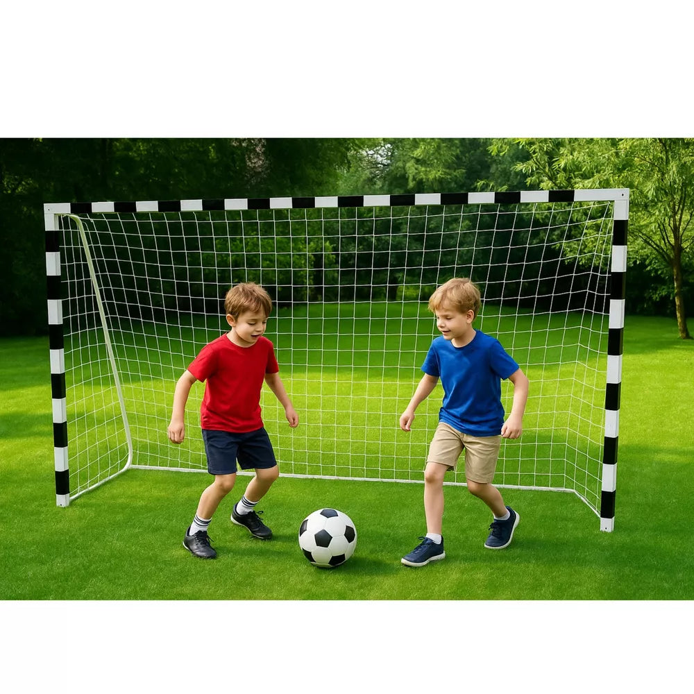 Du berniukai žaidžia futbolą kieme prie vartų, fone matyti medžiai