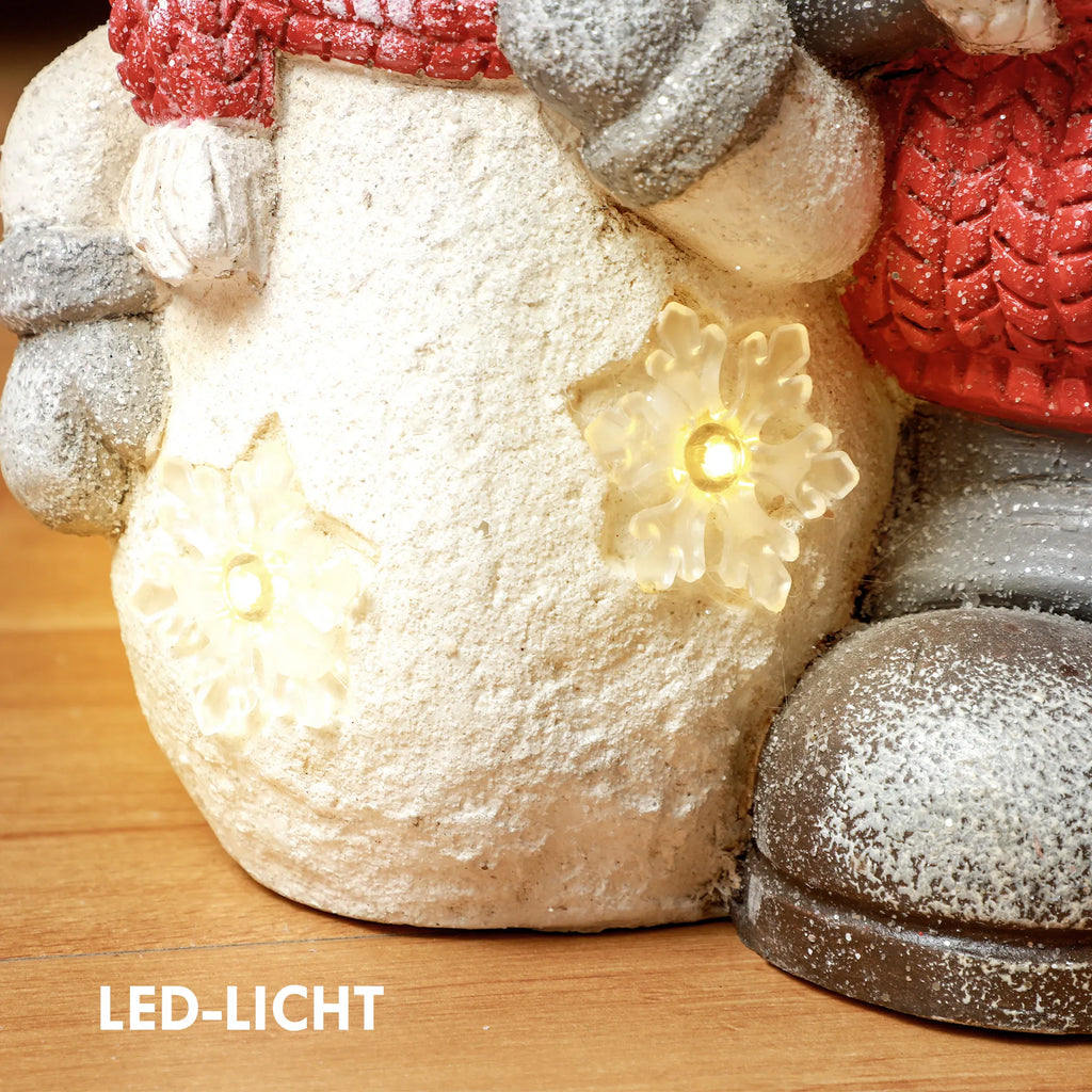 LED-LICHT užrašas ir dvi šviečiančios snaigės ant sniego senio kūno