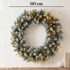 Kalėdinis durų vainikas, 60 cm, su 50 LED lempučių, kankorėžiais ir dirbtiniu sniegu