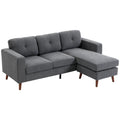 Pilka kampinė sofa su gultu dešinėje, dygsniuotu atlošu ir medinėmis kojelėmis
