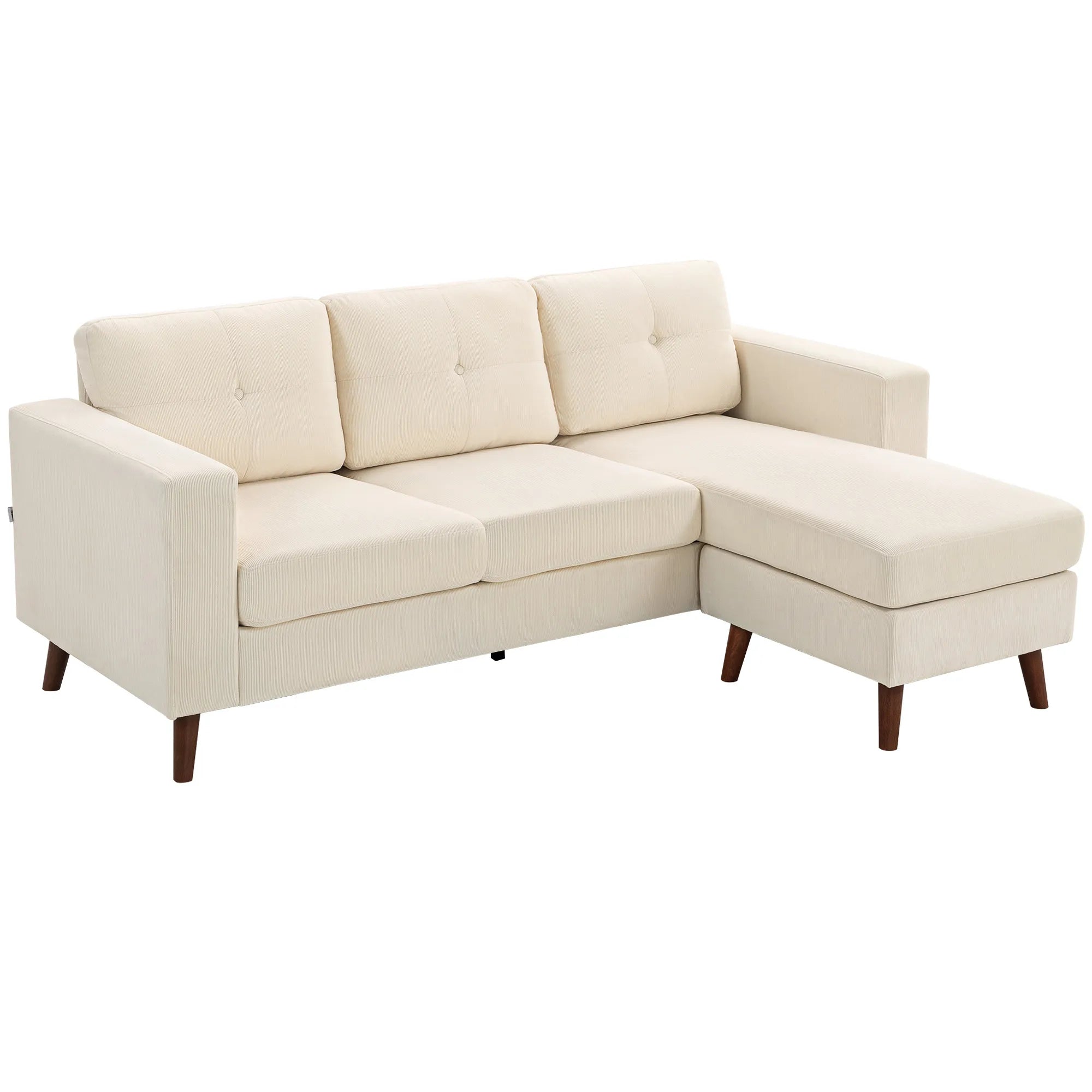 Kreminė kampinė sofa dygsniuotomis pagalvėmis ir rudomis medinėmis kojelėmis