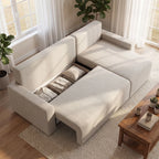 Iš viršaus matoma sofa svetainėje su atidaryta daiktadėže ir žaliais augalais