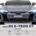 Pilko Audi RS e-tron GT elektromobilio priekis su LED žibintais ir Audi logotipu