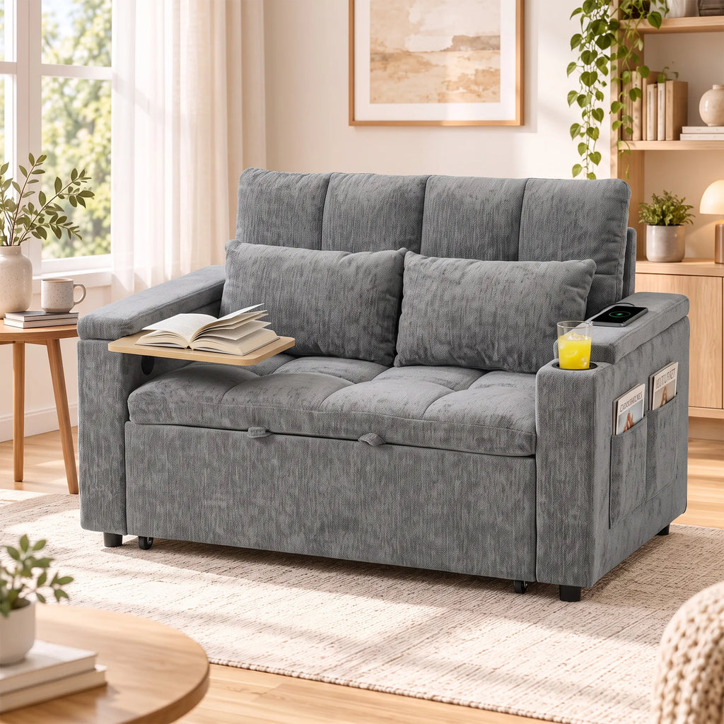 Sudėta pilka sofa su išlankstomu staliuku, knyga ir gėrimu svetainėje