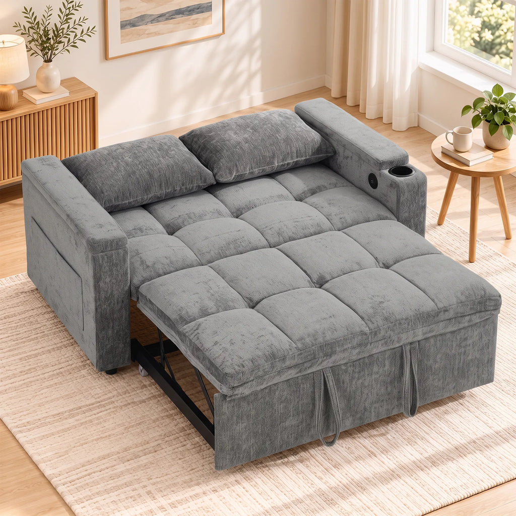Išskleista pilka sofa lova šalia spintelės ir paveikslo kambaryje