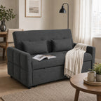 Tamsiai pilka sofa lova svetainėje su pledu ir žurnalu ant pagalvėlių
