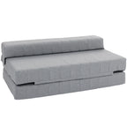 Pilka sulankstoma sofa-lova su dygsniuotu audiniu, vaizdas iš šono baltame fone