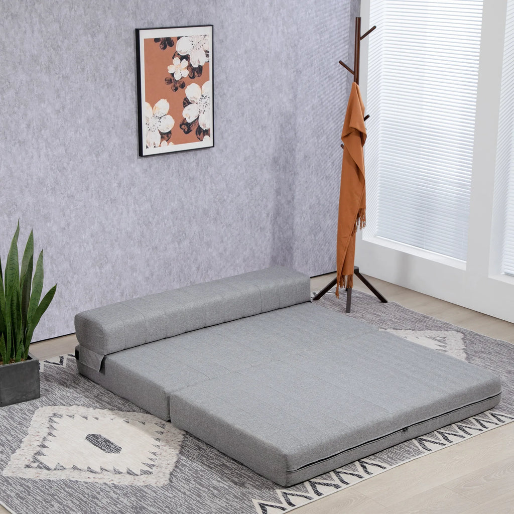 Pilka sofa-lova kambaryje šalia drabužių pakabos ir gėlių paveikslo