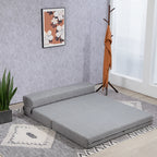 Pilka sofa-lova kambaryje šalia drabužių pakabos ir gėlių paveikslo