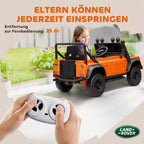 Mergaitė sėdi oranžiniame Land Rover Defender elektromobilyje su muzikos pultu su logotipu