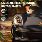 Priekinis žibintas ir Porsche ženkliukas ant matinio juodo kėbulo artimu planu